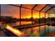 Spectacular sunset view from a screened-in pool area at 14201 Joggins Ave, Port Charlotte, FL 33981