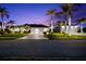 Night view of a single-Gathering home with palm trees and landscape lighting at 14216 Aurella Cir, Port Charlotte, FL 33981