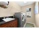 Convenient laundry room with washer, dryer, and utility sink at 14216 Aurella Cir, Port Charlotte, FL 33981