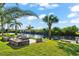 Landscaped patio with fire pit near canal at 14216 Aurella Cir, Port Charlotte, FL 33981