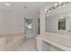 Bathroom featuring a tub, vanity, and window offering natural light at 1443 Quail Lake Dr, Venice, FL 34293