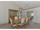 Bright dining area with a vintage cabinet and French doors to the office at 1443 Quail Lake Dr, Venice, FL 34293