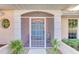 Close-up view of the home's front entrance with a screened storm door at 1443 Quail Lake Dr, Venice, FL 34293