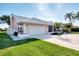 Classic one-story home with a well-manicured lawn and two-car garage, perfect for a Gathering at 1443 Quail Lake Dr, Venice, FL 34293