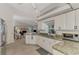 Well-lit kitchen featuring granite counters, stainless steel appliances, and an open layout to the living room at 1443 Quail Lake Dr, Venice, FL 34293