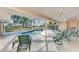 Enclosed lanai with ample seating overlooks pool and backyard at 1443 Quail Lake Dr, Venice, FL 34293