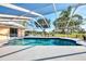 Screened-in pool area boasts lush landscaping and sunny skies at 1443 Quail Lake Dr, Venice, FL 34293