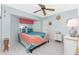 Bedroom with a full-size bed, ceiling fan, and a dresser at 1521 Saint Clair Rd, Englewood, FL 34223