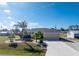 Landscaped yard with palm trees and a paved driveway at 1521 Saint Clair Rd, Englewood, FL 34223