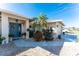 Landscaped front yard with palm trees and a walkway to the entrance at 1521 Saint Clair Rd, Englewood, FL 34223