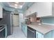 Updated kitchen featuring stainless steel appliances and light teal cabinets at 1521 Saint Clair Rd, Englewood, FL 34223