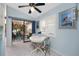 Kitchen breakfast nook with white table and French chairs, view to the patio at 1521 Saint Clair Rd, Englewood, FL 34223