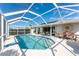 Relaxing pool and patio area with a screened enclosure and outdoor dining furniture at 1521 Saint Clair Rd, Englewood, FL 34223