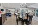 Elegant dining room with chandelier and views to the kitchen at 15410 Seafoam Cir, Port Charlotte, FL 33981