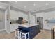 Spacious kitchen featuring a navy blue island and white cabinetry at 15410 Seafoam Cir, Port Charlotte, FL 33981