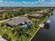 Aerial view of canal-front home with pool and lush landscaping at 15794 Viscount Cir, Port Charlotte, FL 33981