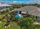 Aerial view of a house with pool and lush landscaping at 15794 Viscount Cir, Port Charlotte, FL 33981