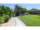 Landscaped backyard with shed and walkway at 15794 Viscount Cir, Port Charlotte, FL 33981