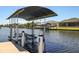 Covered boat lift on a private dock at 15794 Viscount Cir, Port Charlotte, FL 33981