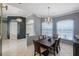 Formal dining room with a chandelier, large windows, and seating for six at 15794 Viscount Cir, Port Charlotte, FL 33981