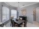 Bright dining area with a chandelier and window views, adjacent to the kitchen at 15794 Viscount Cir, Port Charlotte, FL 33981