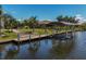 Private dock with covered boat lift on a tranquil canal at 15794 Viscount Cir, Port Charlotte, FL 33981