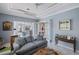 Bright Gathering room with gray sectional and French doors at 15794 Viscount Cir, Port Charlotte, FL 33981