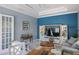 Gathering room features gray sofas, a wood accent wall, and a TV at 15794 Viscount Cir, Port Charlotte, FL 33981