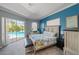 Main bedroom with king-size bed and sliding doors to the pool at 15794 Viscount Cir, Port Charlotte, FL 33981