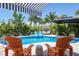 Relaxing pool area with lounge chairs and patio umbrella at 15794 Viscount Cir, Port Charlotte, FL 33981