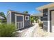 Gray storage shed with white trim and paver walkway at 15794 Viscount Cir, Port Charlotte, FL 33981