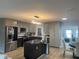 Modern kitchen with island, gray cabinets, and stainless steel appliances at 1755 Georgia Ne Ave, St Petersburg, FL 33703