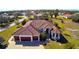 Aerial view of a large house with a three-car garage and a spacious lot at 2 Windward Rd, Placida, FL 33946