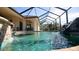 Relaxing pool with waterfall feature and covered lanai at 2 Windward Rd, Placida, FL 33946