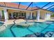 Large, freeform pool with waterfall feature and spacious lanai at 2 Windward Rd, Placida, FL 33946