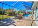 Covered patio with seating area overlooking the pool and lush landscape at 2 Windward Rd, Placida, FL 33946