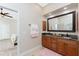 Double vanity bathroom with granite countertops and a large mirror at 210 Capstan Dr, Placida, FL 33946