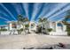 White two-story home with palm trees and circular driveway at 210 Capstan Dr, Placida, FL 33946