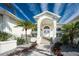 Elegant front entrance with arched entryway and stone steps at 210 Capstan Dr, Placida, FL 33946