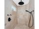 Large walk-in shower with rainfall shower head and black fixtures at 210 Capstan Dr, Placida, FL 33946