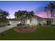 Single-story home with palm trees and well-manicured lawn at 2295 Chilcote Ter, Port Charlotte, FL 33981