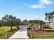 Single-story home with a two-car garage, palm trees, and manicured lawn at 2295 Chilcote Ter, Port Charlotte, FL 33981