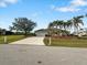 Single story house with a two-car garage and tropical landscaping at 2295 Chilcote Ter, Port Charlotte, FL 33981