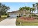 Single-story house with a two-car garage and tropical landscaping at 2295 Chilcote Ter, Port Charlotte, FL 33981