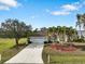 Single-story home with a two-car garage and mature palm trees at 2295 Chilcote Ter, Port Charlotte, FL 33981