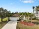 Single-story home with a two-car garage and lush landscaping at 2295 Chilcote Ter, Port Charlotte, FL 33981