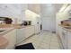 Galley kitchen with white cabinets and stainless steel appliances at 2295 Chilcote Ter, Port Charlotte, FL 33981