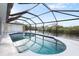 Relaxing pool area with water views from screened enclosure at 2295 Chilcote Ter, Port Charlotte, FL 33981