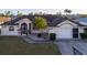 Single-story home with a large yard and driveway at 23111 Mineral Ave, Port Charlotte, FL 33954