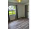 Bedroom with grey curtains and wood-look floors at 23111 Mineral Ave, Port Charlotte, FL 33954